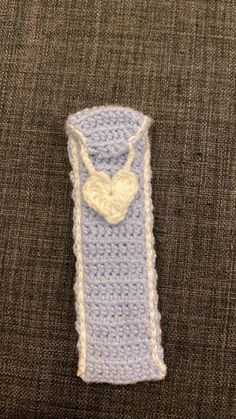 a crocheted blue and white tube with a heart on it