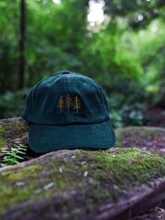 This Pine Trees Corduroy Hat is absolutely perfect for pairing with a flannel, sweatshirt, or pretty much anything really! It's the perfect hat to wear while going camping, hiking, or even a great gift to give to your natural-loving friend or significant other. 10% of the profits from the purchase of this hat will go to the National Park of your choice. * 100% cotton corduroy * Soft, unstructured crown * Cotton twill sweatband and taping * Adjustable buckle This product is made especially for you as soon as you place an order, which is why it takes us a bit longer to deliver it to you. Making products on demand instead of in bulk helps reduce overproduction, so thank you for making thoughtful purchasing decisions! Corduroy Hats, Embroidered Corduroy, Granola Girl Aesthetic, Hiking Hat, Flannel Sweatshirt, Corduroy Hat, Going Camping, Crunchy Granola, Panel Hat