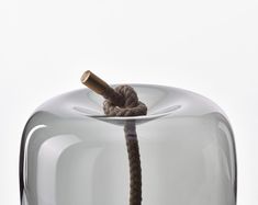 a rope is tied to the top of a glass container