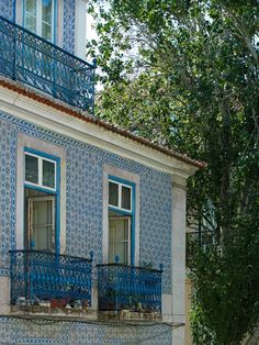 a blue and white building with two balconies