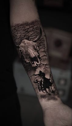 a man's arm with tattoos on it and an image of two men riding horses