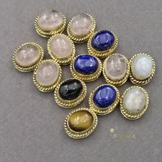 a bunch of different colored stones sitting on top of a table next to each other