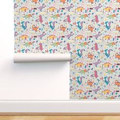 a wallpaper with colorful dinosaurs on it and a white frame in front of the wall