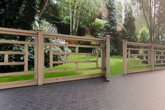 a wooden fence is shown with grass in the background