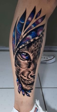 a tattoo on the leg of a person with a cheetah head and feathers