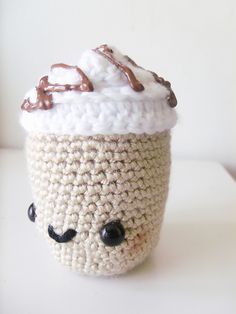 a crocheted coffee cup with chocolate frosting on top