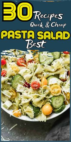 pasta salad with cucumbers and tomatoes in a white bowl on top of a table