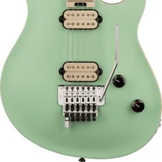 a green electric guitar with four strings attached to it's neck and two knobs on