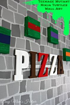 the word pizza painted on a brick wall next to colorful pieces of art that spell out teenage mutant ninja turtles