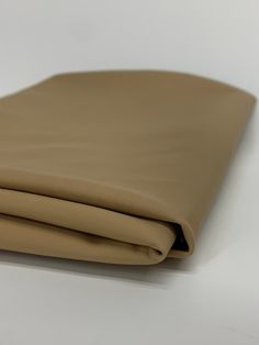 a tan leather sheet folded on top of each other