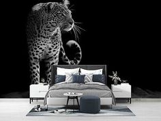 black and white photograph of a bedroom with a leopard on the wall next to it