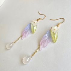 * Elegant dangle floral flower daisy earring. Unique design high quality *Material: glass/14k gold plated hook *Color: white/green/purple 🤍Hypoallergenic 🤍 Handmade with love 🤍Click👇🏻 Find more Jewelry https://www.etsy.com/shop/WandWZONE 🤍 SHIPPING 🤍  * USPS First Class Shipping Service with tracking number * All products will be shipped from USA 🤍  CARE INSTRUCTIONS 🤍  * Avoid chemicals such as shampoo conditioner perfumes or sprays * Avoid getting your jewelry wet * Store jewelry in a Spring Flower Dangle Earrings, Spring Flower Drop Earrings, Spring Teardrop Flower Earrings For Pierced Ears, Spring Gift Teardrop Dangle Earrings, Whimsical Drop Earrings With Flower Charm, Spring Dangle Flower Earrings, Earring Unique, Shrink Plastic Jewelry, Flower Daisy