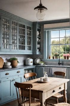 a kitchen with blue cabinets and wooden table in the center, surrounded by wicker chairs