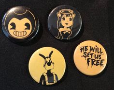 three buttons with cartoon characters on them sitting next to each other in front of a black background