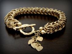 ~The perfect elegant gift for Anniversary Day!~Substantial handcrafted timeless bracelet.  A gorgeous handmade 14k gold filled classic bracelet in a byzantine pattern*Each silver loop is created by a very special method.It has an elegant  luxurious look with eye catching movementThe bracket has a small hearts charms  on it chained together. I can customize different size or shape,(see picture) or even your initials on it.  just contact me for infoThis bracelet has a hybrid look: stylish classic Diva Style, Roman Style, Chainmaille Bracelet, Gold Link Bracelet, Real Gold Jewelry, Chain Maille, Classic Bracelets, Handmade Wire Jewelry, Couture Jewelry