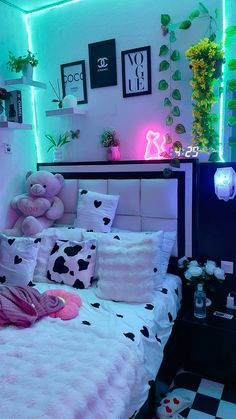 a bed room with a neatly made bed and lots of decorations on the wall above it