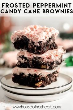 three frosted peppermint candy cane brownies stacked on top of each other