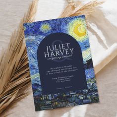 a blue and yellow wedding card with the starry night painting on it, next to some wheat stalks