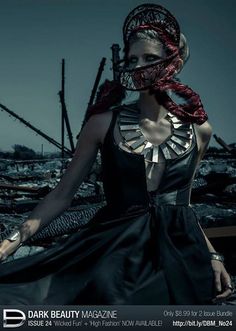 a woman in a dress and headdress is posing for a black and white photo