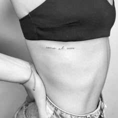 a woman's stomach with the word love tattooed on her lower back and side