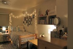 a bedroom with lights on the wall and a small bed in front of a window