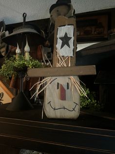 a wooden sign with a face and star on it sitting on top of a mantle