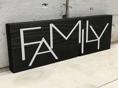 a wooden sign with the word family painted on it