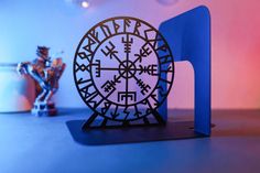 a metal clock sitting on top of a table