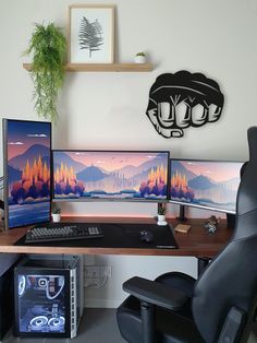 three computer monitors sitting on top of a wooden desk