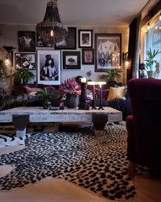 a living room filled with lots of furniture and pictures on the wall above it's coffee table