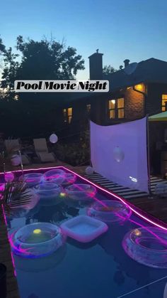 the pool movie night is set up in front of a house with lights on it