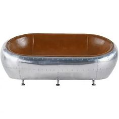 an oval metal tub with two legs and a leather seat on the bottom is shown