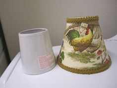 two lampshades sitting on top of a white table