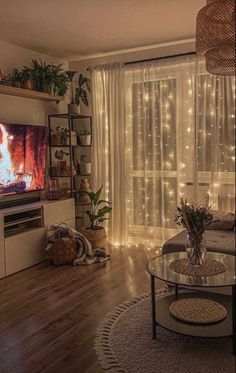 a living room filled with furniture and a flat screen tv sitting on top of a wooden floor