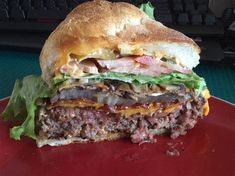 a close up of a sandwich on a plate with a keyboard in the back ground