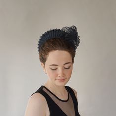 From our UNIQUE COLLECTION this very flattering halo crown style is very much in vogue this season. This one has been hand blocked and wired using traditional millinery techniques. Formed from navy sinamay straw and overlaid with pleated crin.  A sculptural shell adorns one side. ONE OF A KIND - READY TO SHIP  UK - STANDARD DELIVERY  1-2 DAYS           EXPRESS NEXT DAY  INTERNATIONAL  -STANDARD DELIVERY  5-10 DAYS                                    EXPRESS 3-4 DAYS CHOOSE DELIVERY METHOD AT CHEC Structured Crown Headpiece For Royal Ascot, Adjustable Crown Headpiece For Evening, Royal Ascot Headband For Church, Adjustable Round Crown Headpiece For Evening, Elegant Party Headband With Tall Crown, Elegant Tall Crown Headband For Parties, Elegant Fitted Crown Headpiece, Adjustable Hair Accessories With Matching Headband, Adjustable Headband For Church