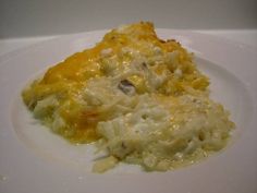 a white plate topped with food covered in cheese