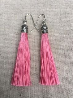 Chic pink tassel earrings!  They would add a pop of color to any outfit for any occasion.  Dress them up or down.  They are timeless and versatile.  They are lightweight, fun and unique!The tassels measure 2 1/8” long by 1/4” wide.  They hang from simple silver ear wire hooks.  Overall drop length is about 2 1/4”.  Metal is allergy free plated silver.These are my latest creation!  I have them available in many colors!  Find them all under the category tassel earrings in my shop.Thanks for stoppi Pink Tassel Drop Earrings, Adjustable Pink Tassel Drop Earrings, Pink Dangle Tassel Earrings, Pink Tassel Earrings As Gift, Pink Adjustable Dangle Tassel Earrings, Pink Tassel Jewelry As A Gift, Pink Earrings With Latkans For A Gift, Pink Latkans Earrings For Gift, Pink Fringe Earrings For Summer