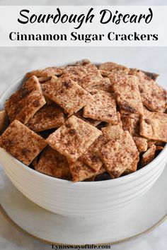 cinnamon sugar crackers in a white bowl with text overlay that says cinnamon sugar sourdough crackers