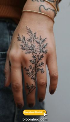 a woman's hand with tattoos on it and flowers tattooed on the palm area