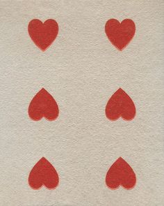 four red hearts are arranged in the shape of heart shapes on a white paper background