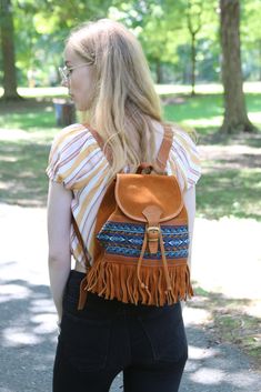 "Use this handcrafted leather backpack for school, work, traveling, or just the day to day. The adjustable straps allow for your personal comfort and the array of pockets help you to stay organized. The unique patterned accents give your backpack a little extra personality.  PRODUCT INFO: Handcrafted in Ecuador Dimensions: Height: 11\" Width: 9.5\" Depth at base: 6\" Material: Leather Cleaning instructions:  For light cleaning, wipe with a damp cloth; for more serious cleaning, please contact a leather cleaning professional. www.yapacollections.com We have done our best to accurately represent the colors of the blankets in our photos, but due to variations in individual computer monitor settings, the actual colors may vary from what you see on your screen. We donate 5% of our net sales to Bohemian Leather Backpack With Adjustable Strap For Daily Use, Bohemian Leather Backpack With Adjustable Strap For Travel, Bohemian Leather Backpack For Everyday Use, Bohemian Leather Backpack For Everyday, Everyday Bohemian Leather Backpack, Bohemian Leather Backpack With Adjustable Strap, Bohemian Brown Backpack For Everyday, Everyday Brown Bohemian Backpack, Tapestry Backpack