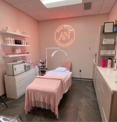 a room with a bed, desk and shelves on the wall that have various items in it