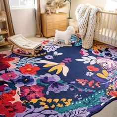 a baby crib with a flowered rug on the floor