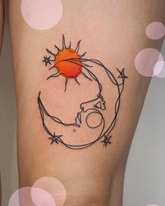 a woman's thigh with a sun and moon tattoo on it