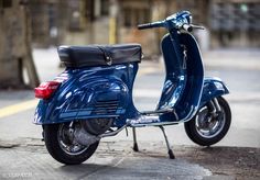 a blue scooter is parked on the street