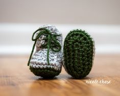 a pair of crocheted shoes sitting on top of a wooden floor