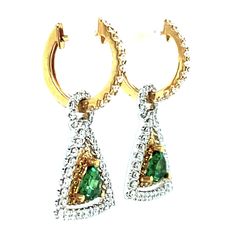 These earrings are gorgeous and stunning! Two trillion cut tsavorite garnets are set with round brilliant-cut diamonds and bright yellow sapphires. The garnets are a beautiful, brilliant grass-green color. The yellow sapphires and diamonds compliment and contrast with the green garnets and add even more sparkle. They are made of 18k white and yellow gold by our Master Jewelers in Los Angeles. Tsavorite garnets, 4.00 millimeters, .67 carat total118 round brilliant cut diamonds, .95 carat total36 Gold Triangle, Tsavorite Garnet, Green Garnet, Grass Green, Yellow Sapphire, Round Brilliant Cut Diamond, Bright Yellow, Brilliant Cut Diamond, Round Brilliant