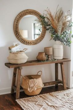 a wooden table sitting next to a mirror on top of a wall