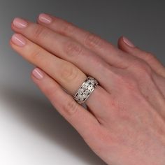 This exquisite wide band style ring features a pierced design and is accented with forty-four (44), bead set, round single cut diamonds. The ring measures 9.1mm wide and 3.0mm thick. This ring is a size 5.75 and cannot be resized due to the design. Wide Band Diamond Ring With Pave Setting, Wide Band Wedding Ring With Single Cut Diamonds, Elegant Wide Band Ring With Decorative Band For Promise, Elegant Wide Band Promise Ring With Decorative Band, Wide Band Diamond Ring With Diamond Cut, Wide Band Wedding Ring With Brilliant Cut, Wedding Wide Band Ring With Brilliant Cut, White Gold Wide Band Wedding Ring, White Gold Wide Band Promise Ring